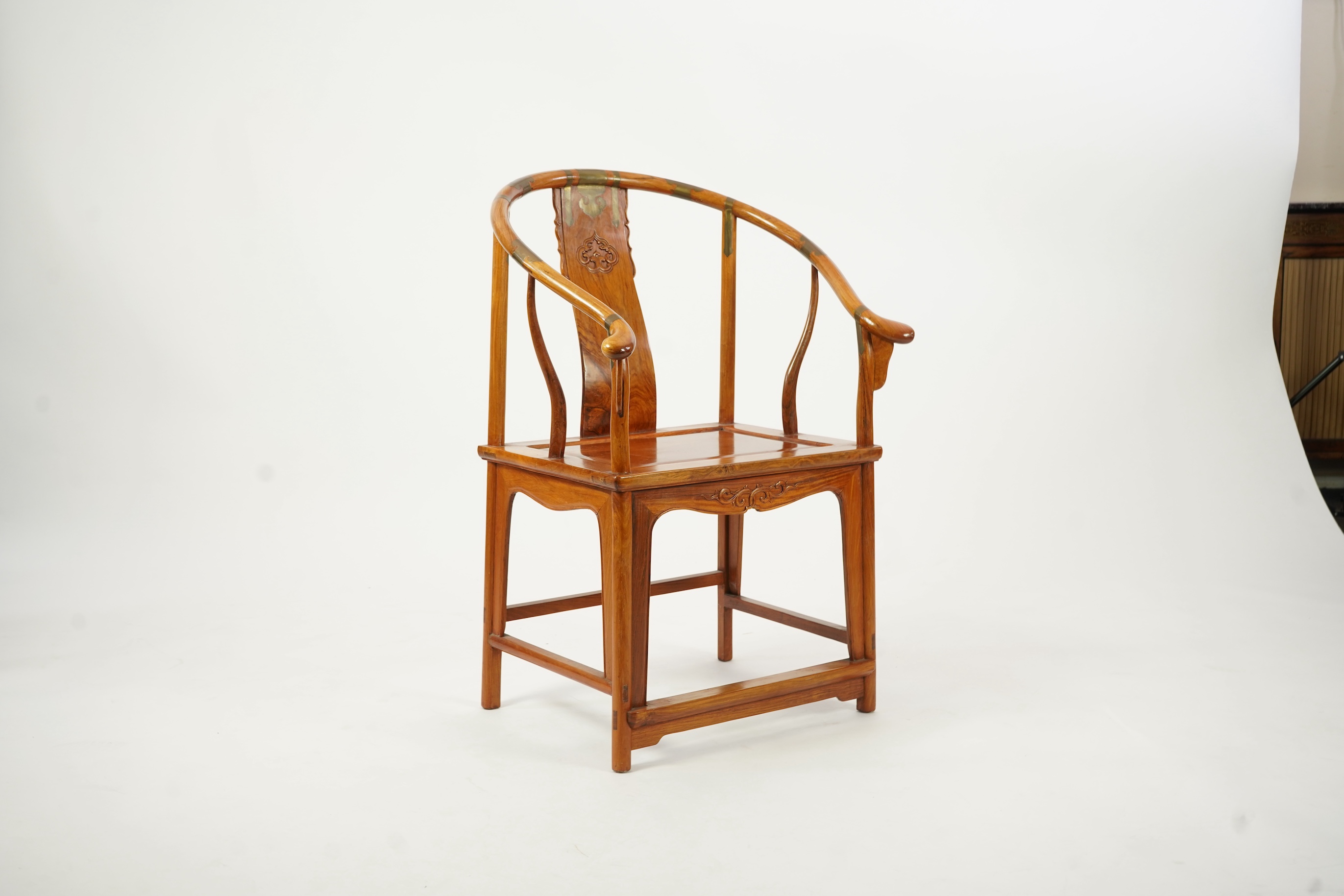 A Chinese huanghuali and brass mounted horseshoe-back armchair, quanyi, late 19th century